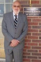 Photo of attorney Harold H. Parker standing outside firm office building